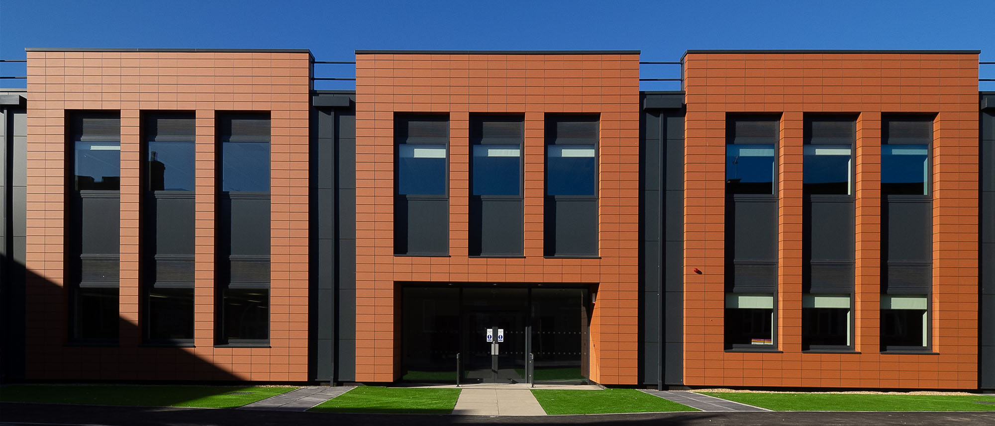Replacement windows and doors to an existing brick school building