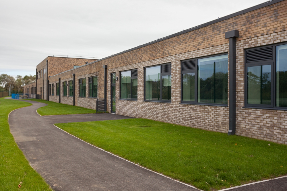 Long single-storey building with replacement windows